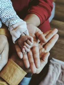 Hands to show a mum dad and new baby